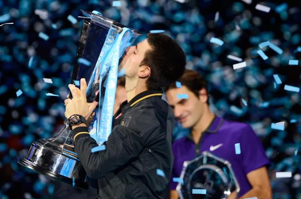 SABOREANDO LA GLORIA. Djokovic celebra su título con Federer en segundo plano. TELAM