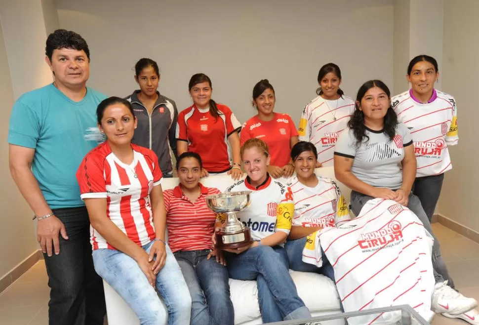 LA COPA SE MIRA Y NO SE TOCA. Las santitas posan con el trofeo luego de consagrarse como las primeras campeonas, en la historia del fútbol femenino, de un torneo argentino organizado por AFA. 