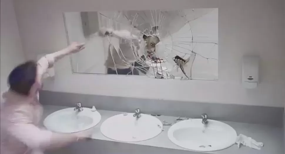 IMPACTANTE. El rostro ensangrentado de una persona aparece sorpresivamente a través del espejo. CAPTURA DE VIDEO