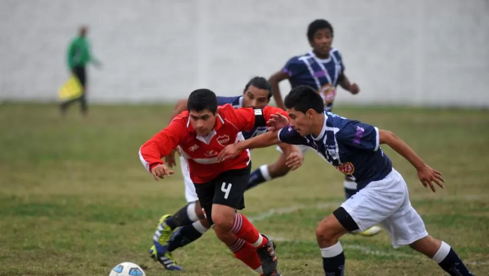 BUENA TAREA. Pablo González, de All Boys, se lleva la pelota ante la marca de Argañaraz, de San Juan. 