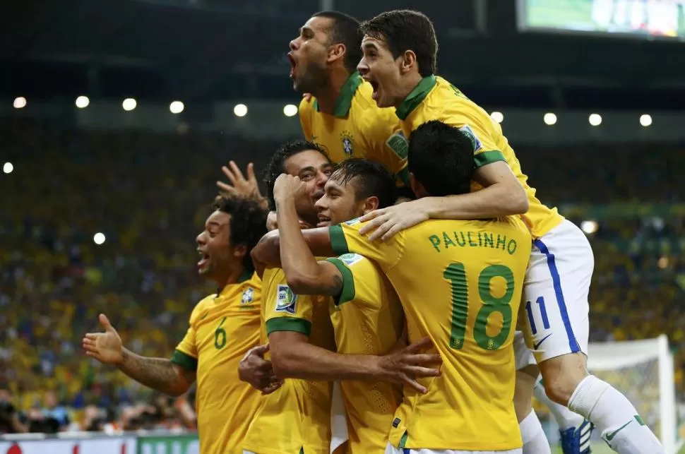 MONTAÑA DE ALEGRÍA. Paulinho, Oscar, Alves y Fred se abalanzan sobre Neymar, que anotó su tercer gol en la competencia. REUTERS