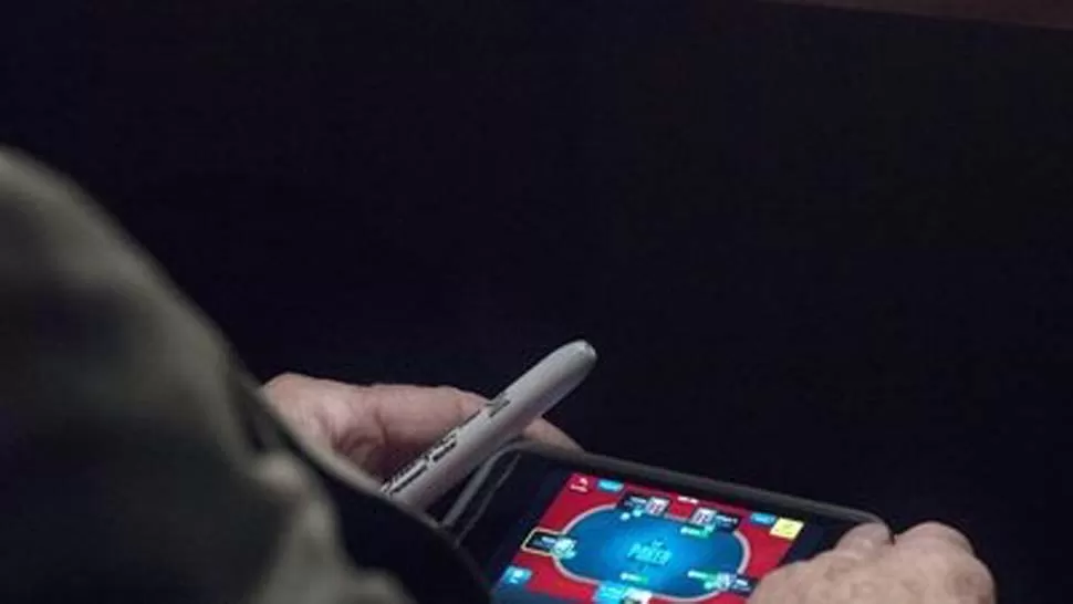 PILLADO. Imagen del senador John McCain jugando al póker a través de su móvil en un debate sobre la posible intervención militar en Siria. THE WASHINTGON POST