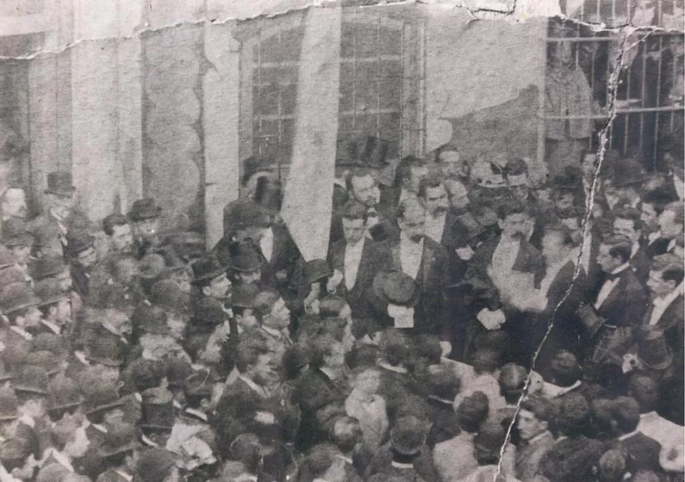 SILVANO BORES. Calvo, de barbita y con galera en la mano, se lo divisa en esta borrosa foto de 1893, hablando en la Casa Histórica. El Salón de la Jura había sido cubierto por un telón pintado LA GACETA / ARCHIVO
