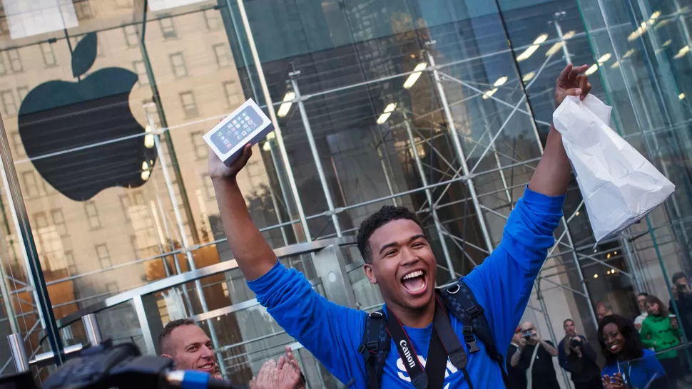 EUFORIA. Un fanático de Apple celebra ser uno de los primeros en adquirir el nuevo iPhone.  REUTERS