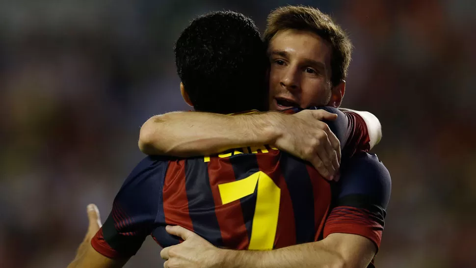 ABRAZO DE TRIUNFO. Messi festeja junto a Pedro, autor de tres goles. REUTERS