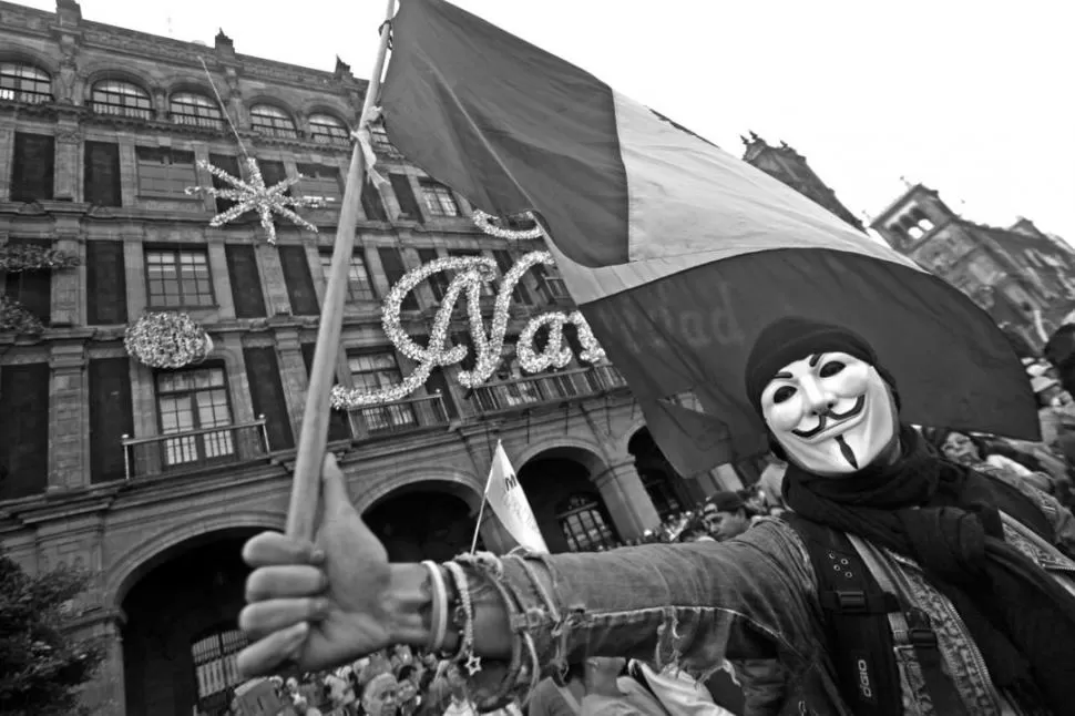 CON MÁSCARAS. Los manifestantes terminaron con violencia la marcha. REUTERS 