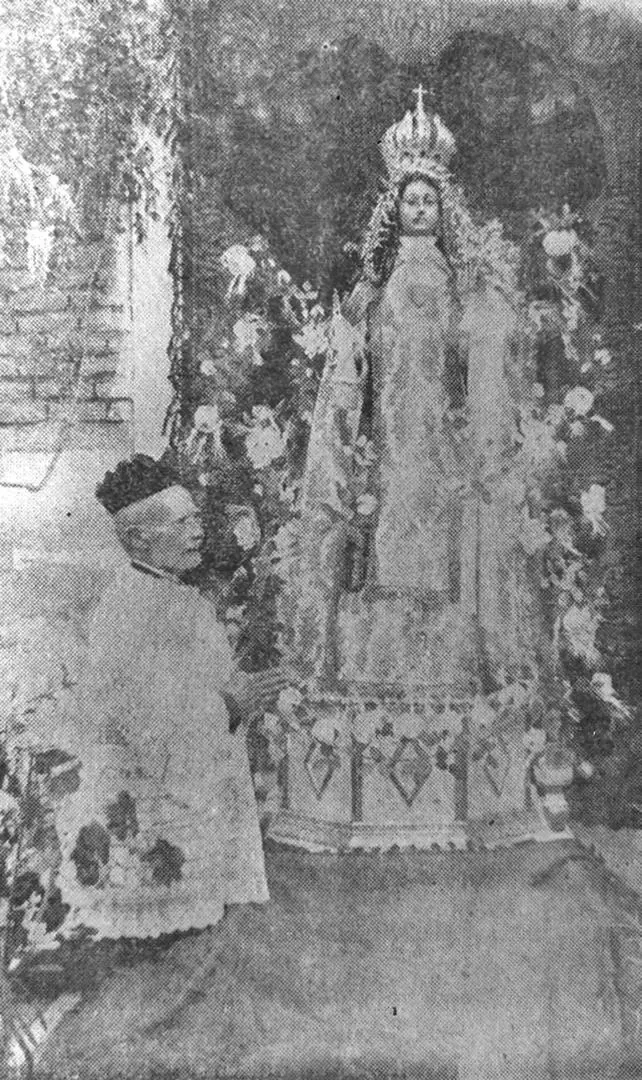 PADRE MIGUEL ROMÁN. Borrosa foto del inolvidable párroco de Medinas rezando al pie de la Patrona de la villa. la gaceta / archivo