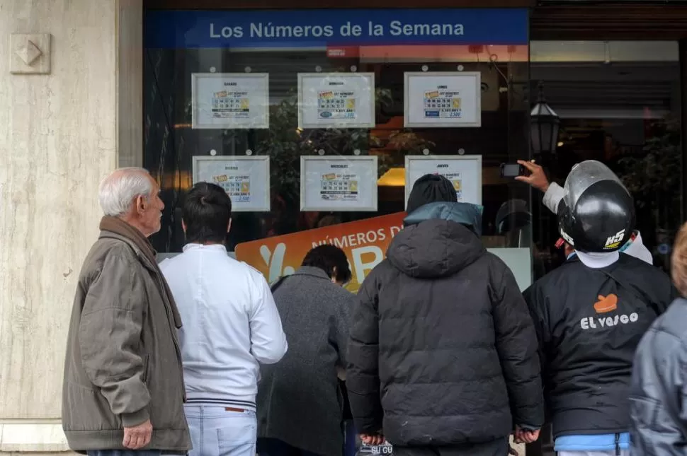 TODOS ATENTOS. Los lectores se amontonan frente a LA GACETA para controlar sus respectivas tarjetas. la gaceta / foto de oscar ferronato