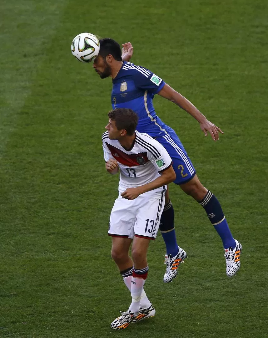 UNA CONSTANTE. Garay le gana por arriba a Müller durante el primer tiempo del partido jugado en el Maracaná. Demichelis también se destacó a su lado.  
