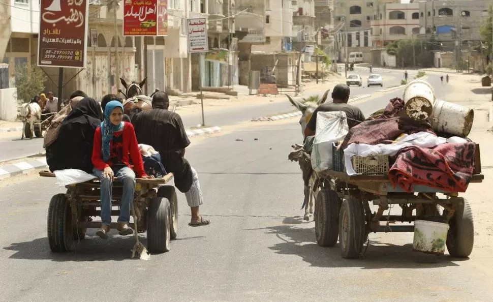 ESCAPAN EN LO QUE PUEDEN. Ciudadanos dejan la ciudad de Gaza. REUTERS