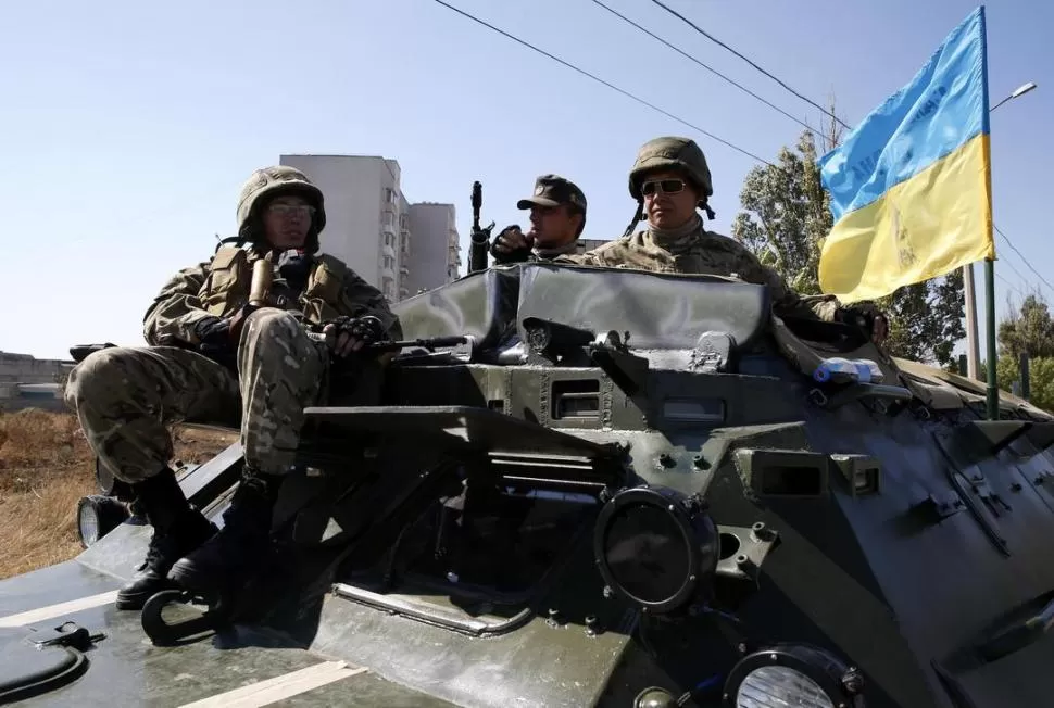 CALMA. Soldados ucranianos junto a un tanque, en las afueras de Mariupol. reuters