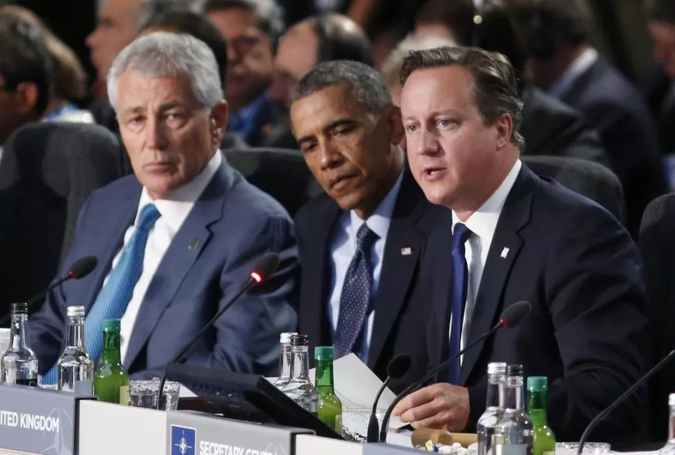 LA CUMBRE. Hagel, jefe del Pentágono y Obama escuchan a Cameron. reuters