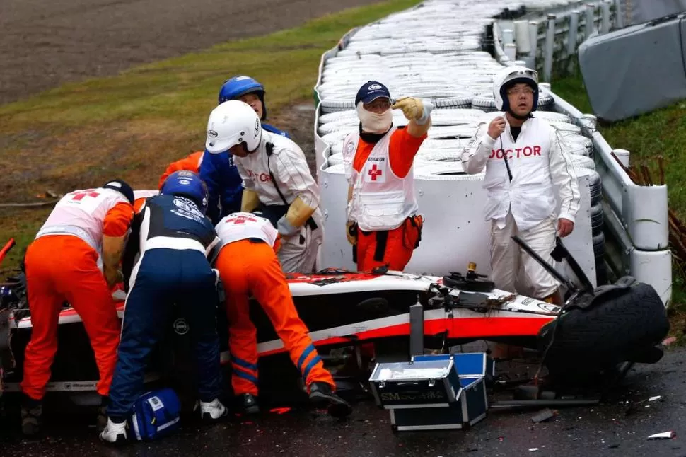 DESESPERACIÓN. Los auxiliares de pista japoneses rodearon el Marussia de Jules Bianchi, en el afán de brindarle los primeros auxilios. El piloto estaba inconsciente. 