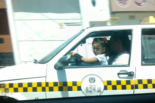 Un taxista fue fotografiado con una nena al volante