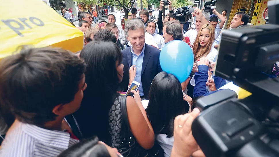 EN EL CENTRO. Macri se sacó fotos con peatones antes de partir a Salta.  