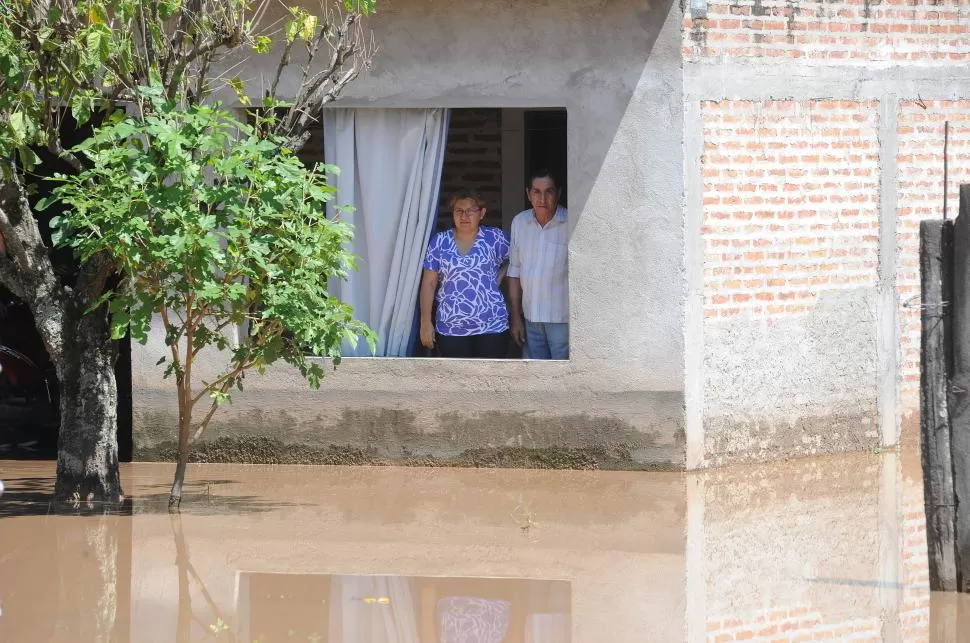 TRISTEZA. Dos vecinos observan el agua que cubre una calle del pueblo. la gaceta / foto de hector peralta 