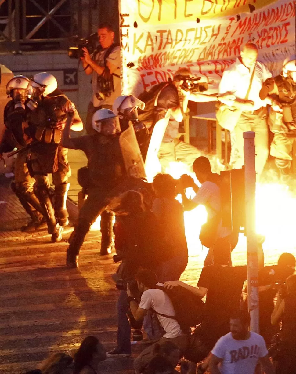 EN ATENAS. Manifestantes griegos chocaron ayer con la policía, cerca del edificio del Parlamento. reuters