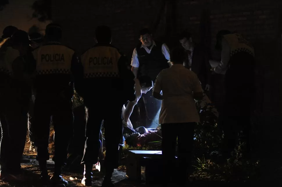 REVISIÓN. Los médicos de la Policía comienzan a  examinar el cuerpo de la víctima anoche a las 20.15. la gaceta / foto de hector peralta 