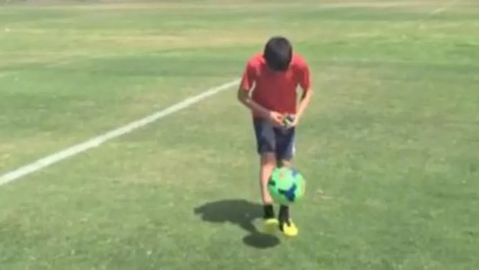 Brillante y crack a la vez: un niño hace pataditas mientras arma el cubo rubik