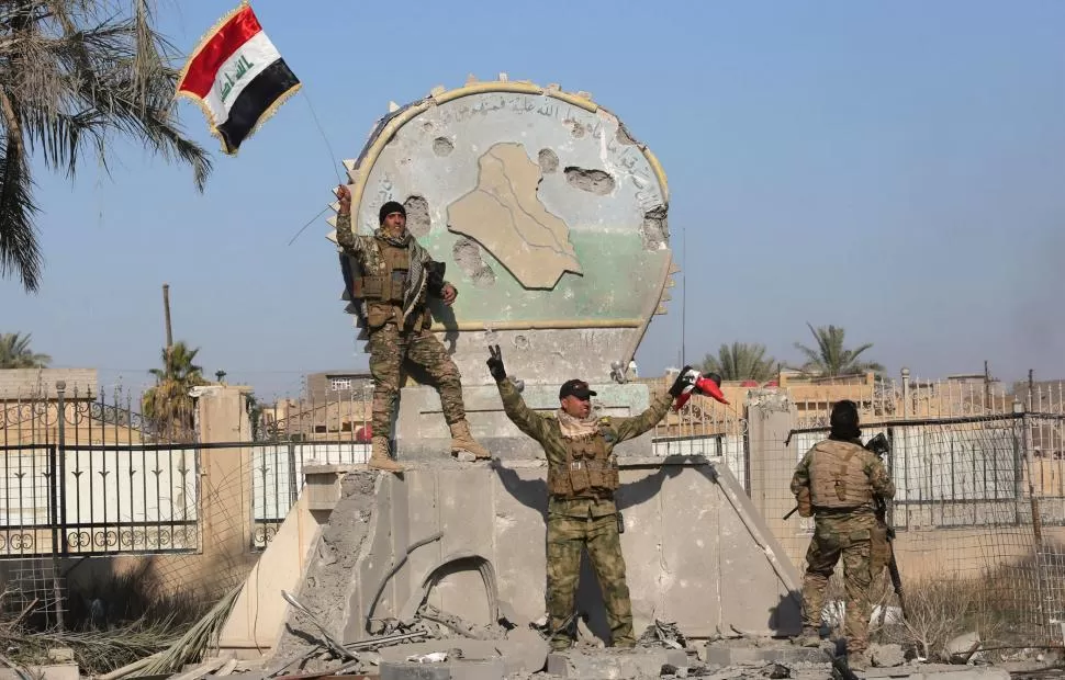 EL LUNES. Soldados iraquíes izaron la bandera al recuperar Ramadi. rueters
