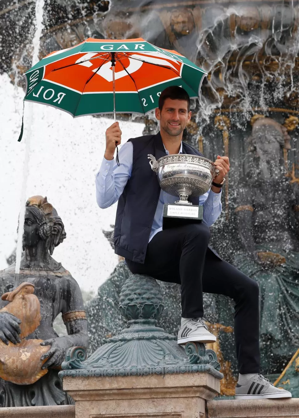 CUMPLIÓ LA TRADICIÓN. Djokovic posó con el trofeo ganado en Roland Garros. Reuters