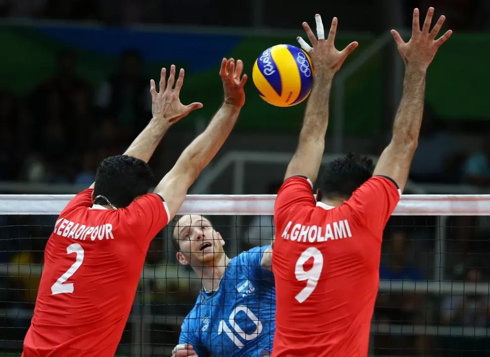 DOMINÓ LA RED. González intenta superar el bloqueo de los jugadores de Irán. reuters