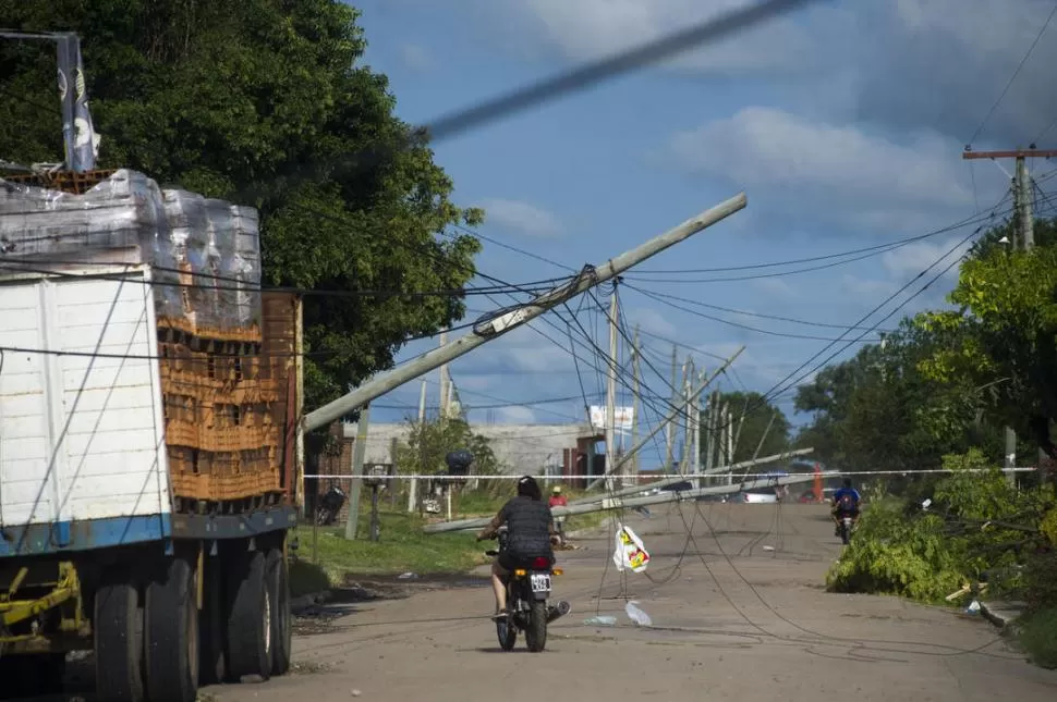 EL DESASTRE. Los postes del tendido eléctrico y sus cables se inclinan sobre las calles de Banda del Río Salí. En la vereda opuesta, restos de árboles caídos. la gaceta / FOTO DE DIEGO ARAOZ