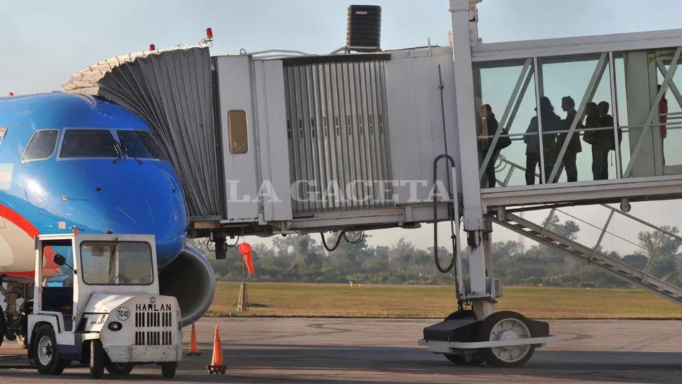 AEROPUERTO BENJAMÍN MATIENZO. Los pasajeros esperan en la manga su turno para subir a un avión de Austral. ARCHIVO