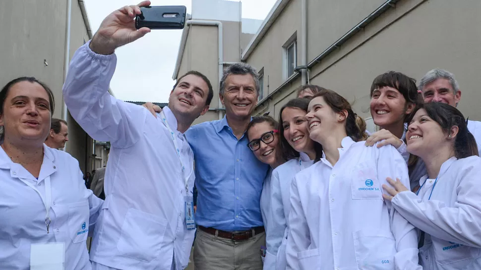 EN PARANÁ. Macri se toma una selfie con trabajadores de un laboratorio. DYN