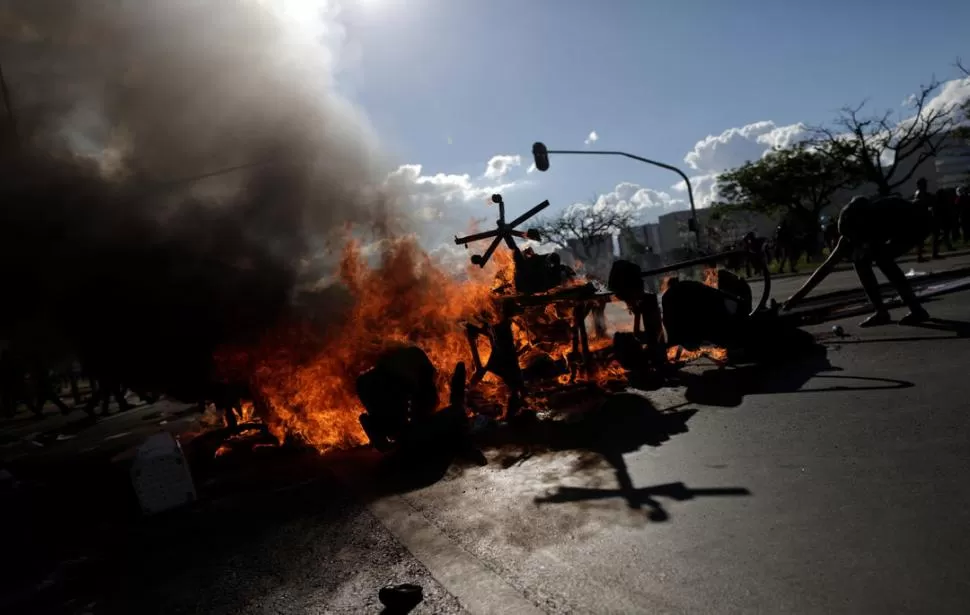 TODO VALE. Sillas, contenedores de basura, cubiertas y desperdicios sirvieron para que los manifestantes prendieran fuego en las avenidas de Brasilia. Reuters