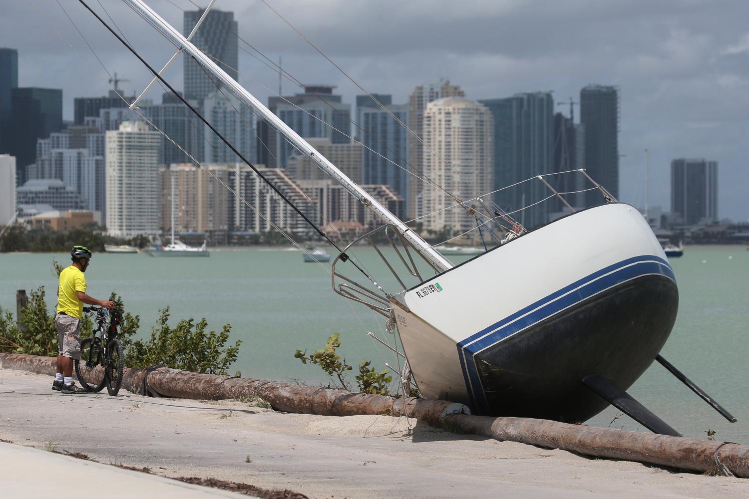 LUEGO DEL HURACÁN. Un hombre mira un velero que quedó a metros de una calle luego del paso de Irma. REUTERS