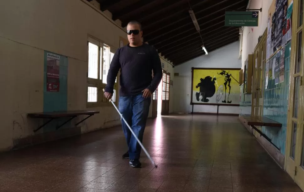 EL LUGAR TANTAS VECES RECORRIDO. Franco Salas camina con su bastón blanco por el pasillo de la Facultad de Filosofía y Letras de la UNT. LA GACETA / FOTOS DE JOSÉ NUNO.-