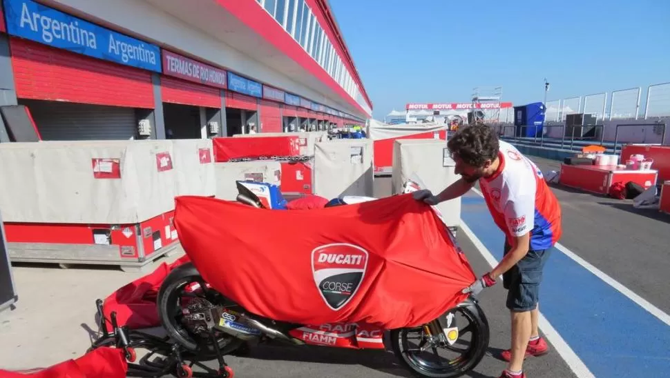 PREPARATIVOS. Uno de los asistentes mecánicos del equipo Ducati acomoda una de las máquinas en el sector de boxes.  @pramacracing