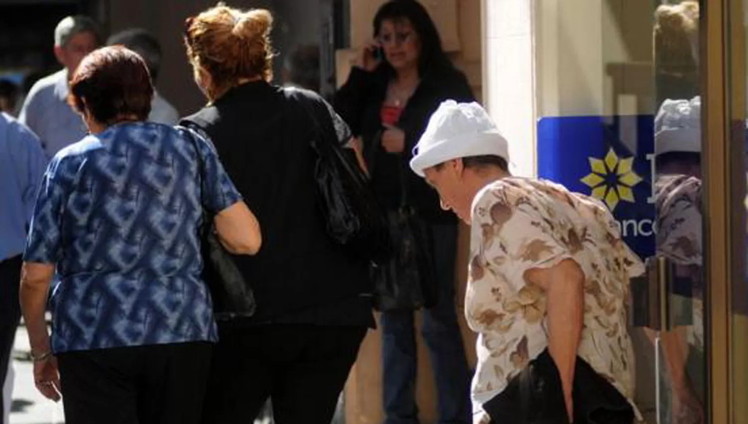 TERCERA EDAD. Tres mujeres mayores salen de un banco del microcentro. ARCHIVO