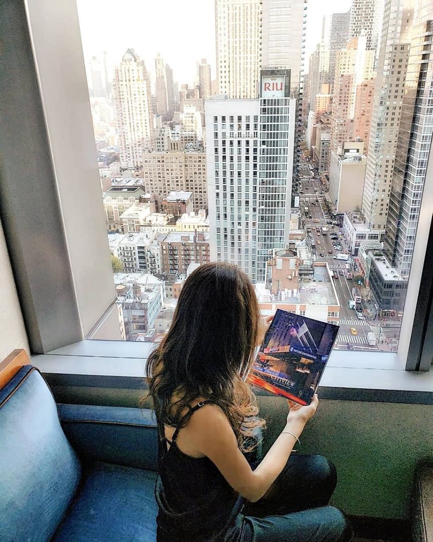 CON ALTURA. Sofía lee una revista y por la ventana se observan los imponentes edificios de Nueva York.  