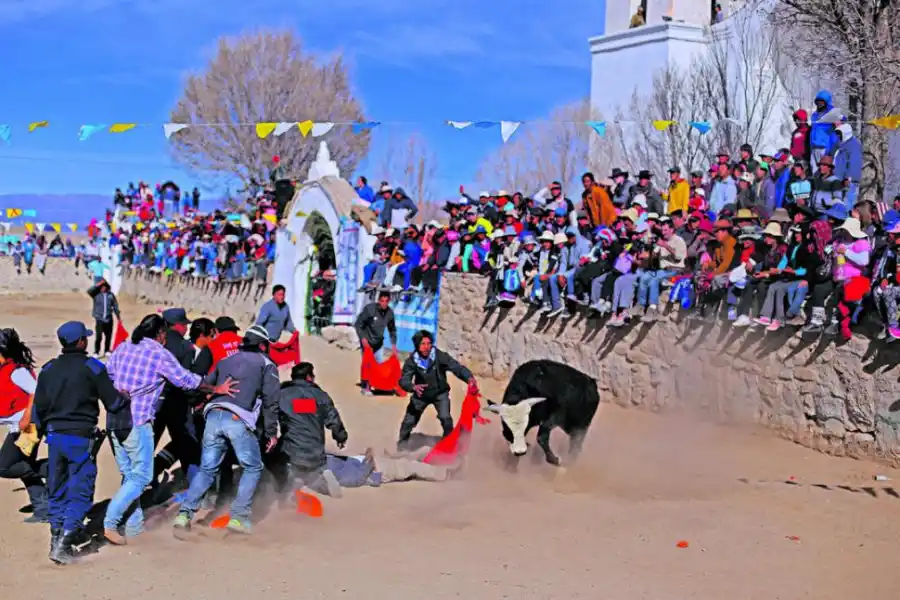EN EL CORRAL. Un torero cae al suelo y otros lo ayudan a espantar el toro.-