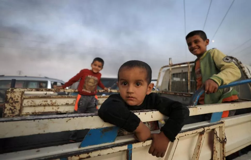 CON LO PUESTO. Familias enteras se desplazan con lo que pueden cargar, para escapar de los bombardeos.  Reuters