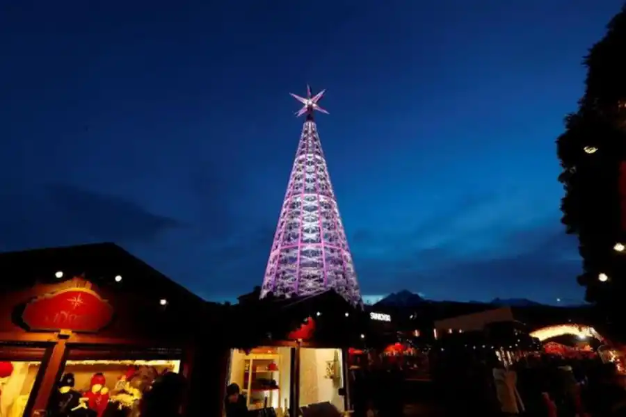 AUSTRIA. Un árbol, en el centro del paseo. La gente visita un colorido mercado navideño en Innsbruck.