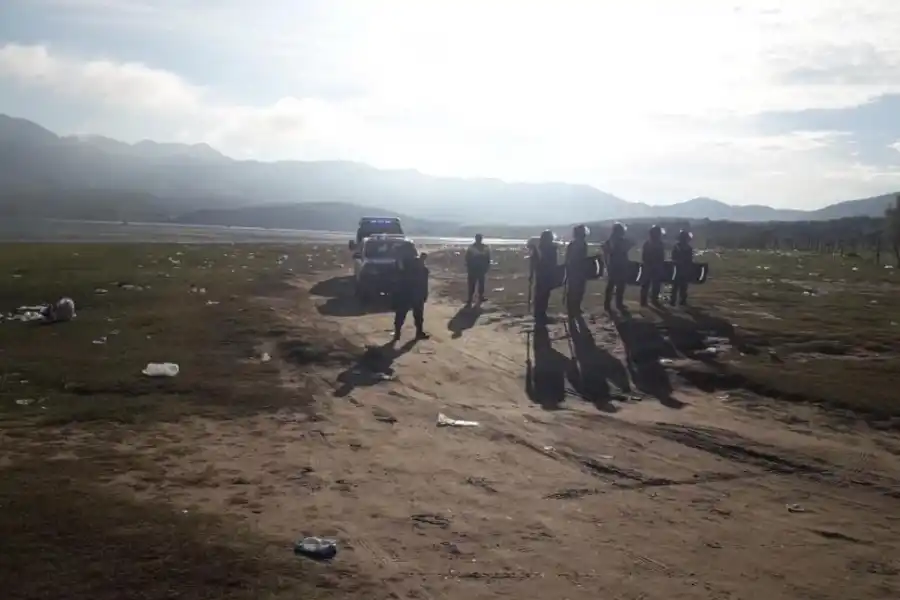 BARRIDO. Los Policías se retiran de la zona del perilago cuando ya no queda nadie; minutos antes era un descontrol.         