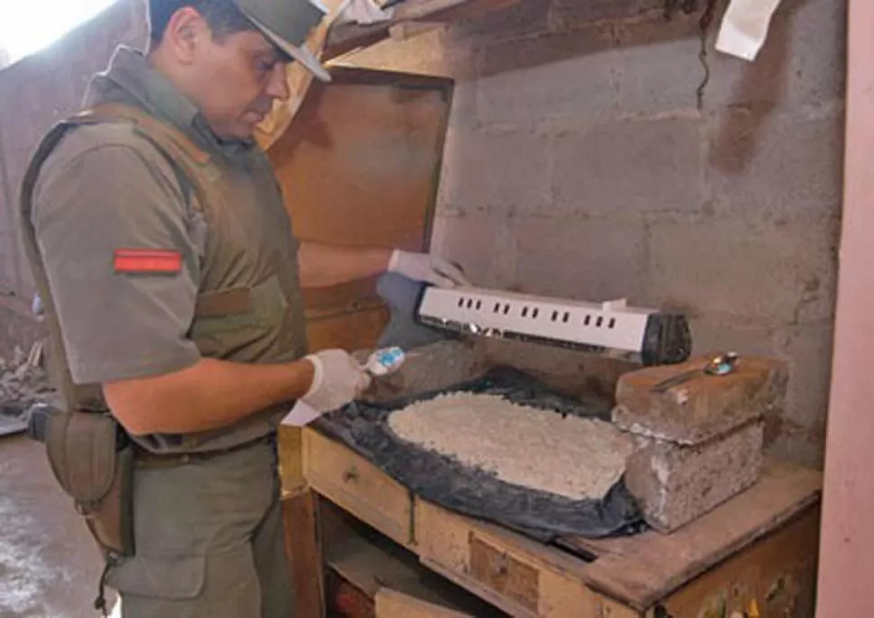 EN TAFÍ DEL VALLE. Un gendarme analiza  la cocaína que se secaba en una cocina desactivada en 2006.