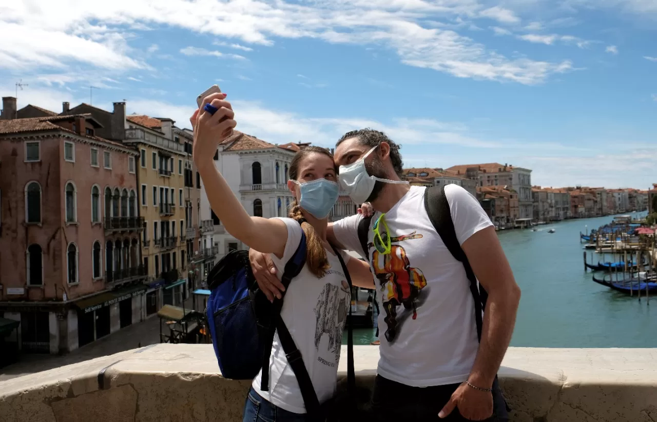 Una pareja de turistas pasea por Venecia con tapabocas. REUTERS 