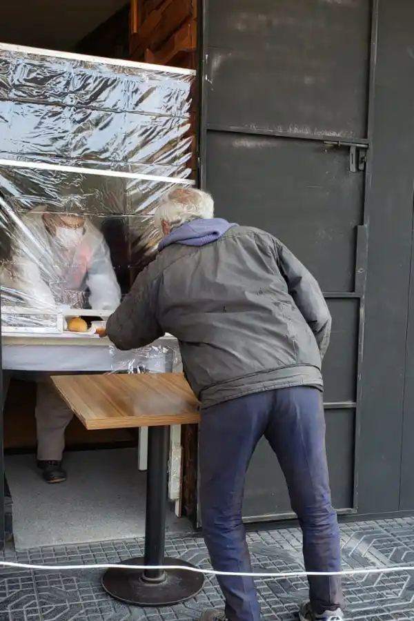 Trabajadores de un bar cerrado por la pandemia, entregan guiso a personas en situación de calle