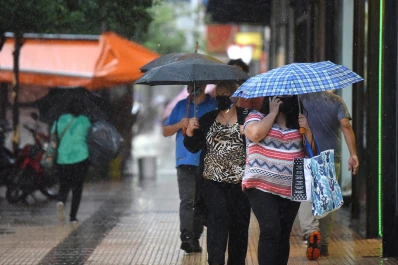 Protegerse el cuerpo y el barbijo con el paraguas