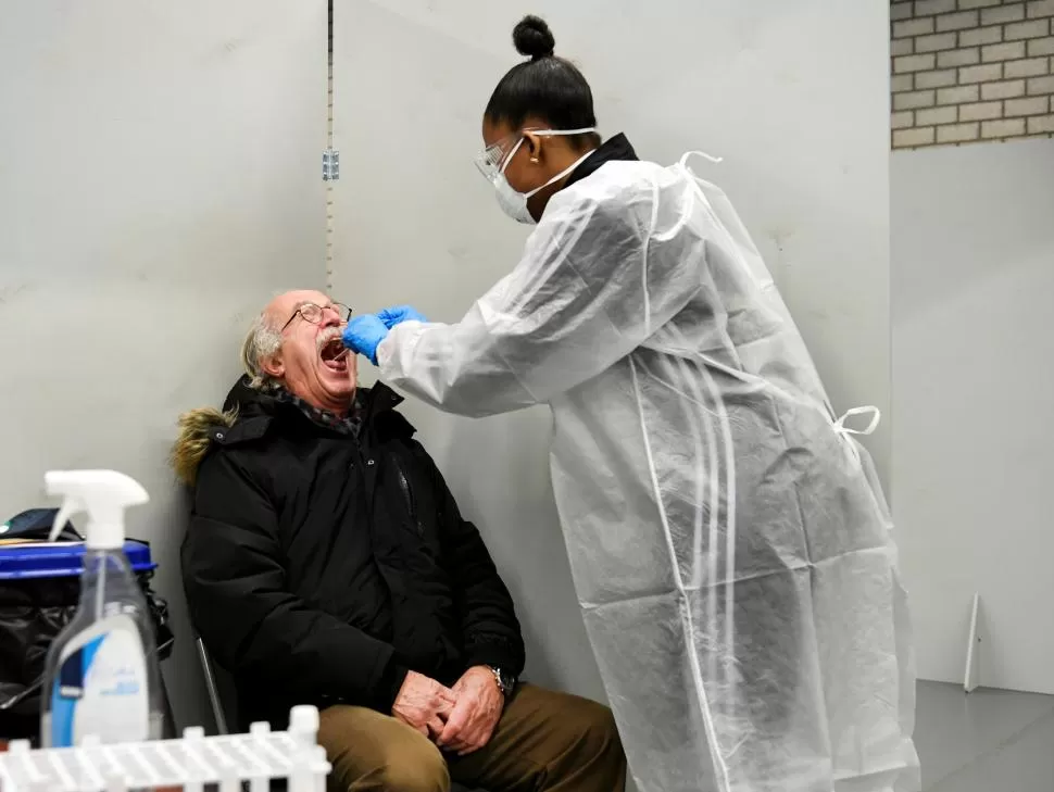 PAÍSES BAJOS. Un médico toma una muestra bucal a un paciente. 