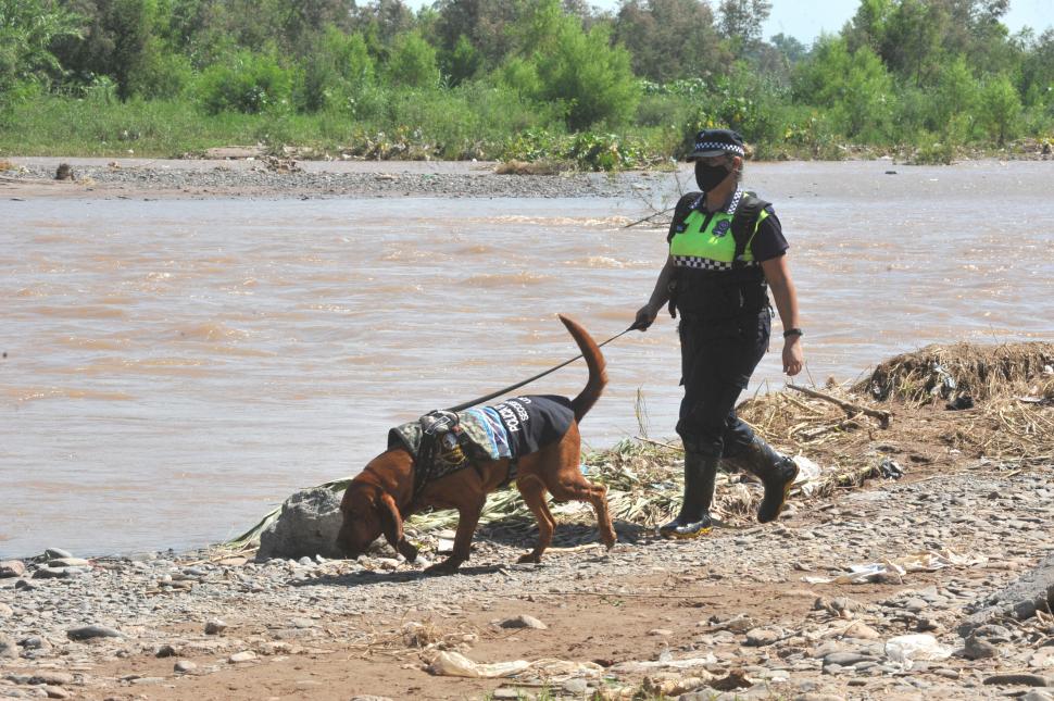 BUSCADORES. Por agua y por tierra, la Policía recorre el río Salí.  