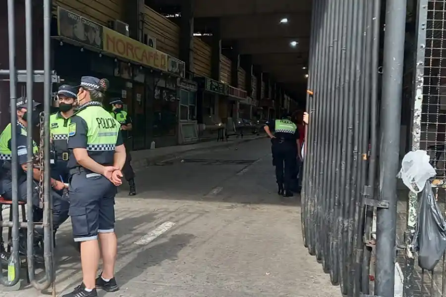 LOS POLICÍAS CUSTODIAN el retiro de la mercadería y además evitan que ingresen más personas. FOTO FLORENCIA ZURITA.