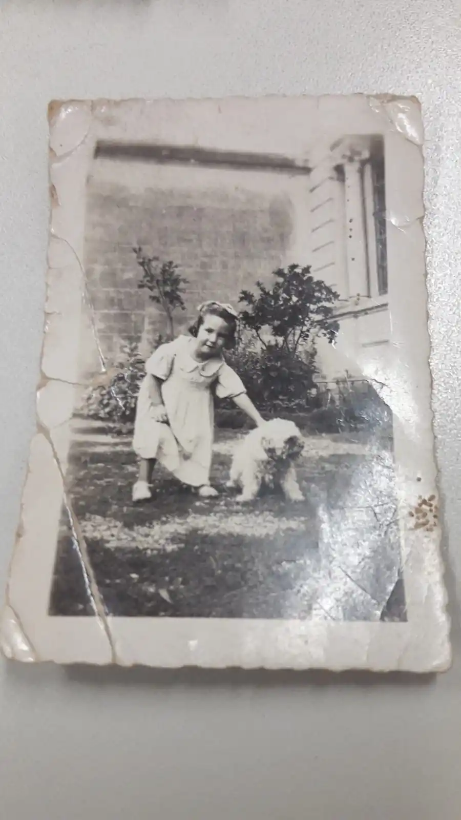 DÉCADA DEL 30. Marta acaricia a Chicha, la perra de su abuela, en el jardín de la Casa Histórica. 