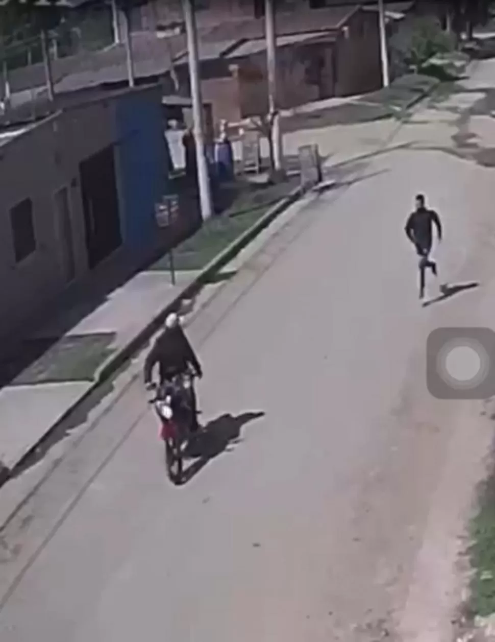 EN PLENA FUGA. El asaltante que hirió de dos balazos al comerciante corre a buscar a su cómplice que lo espera con la moto encendida. 