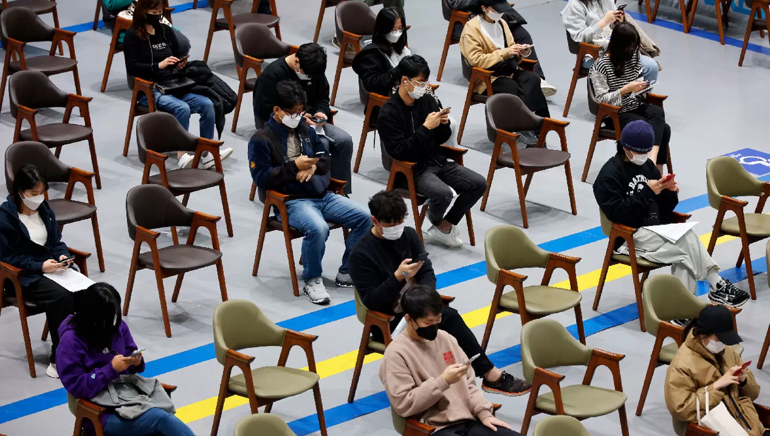 A LA ESPERA. Decenas de personas aguardan recibir una vacuna en Seúl, la capital de Corea del Sur.