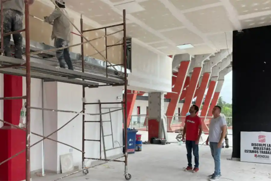 EN PLENA OBRA. Ledesma (de rojo) y Sogno (de blanco) supervisan los trabajos en la zona media de la platea central de La Ciudadela.